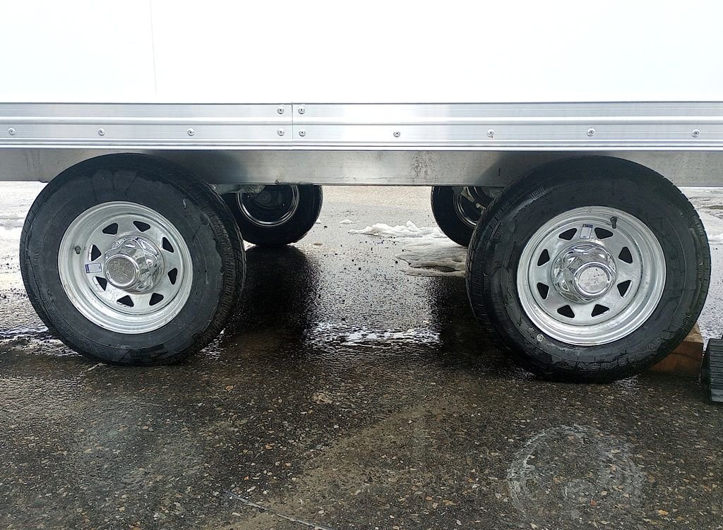 2024 Mission Trailers 24 ft Deckover – Galvanized Package – Close-up view of the dual axles and galvanized wheels with tires