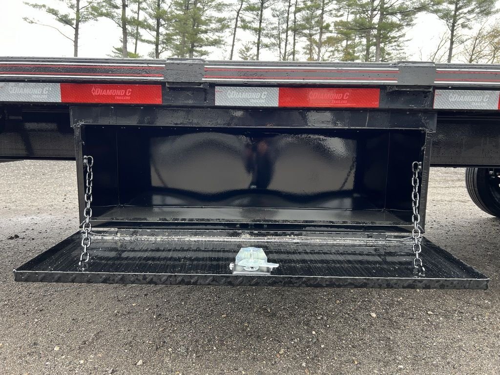 2024 Diamond C 24 ft Deckover – Blackwood Deck – Open side mounted tool box showing the interior compartment and chain supports