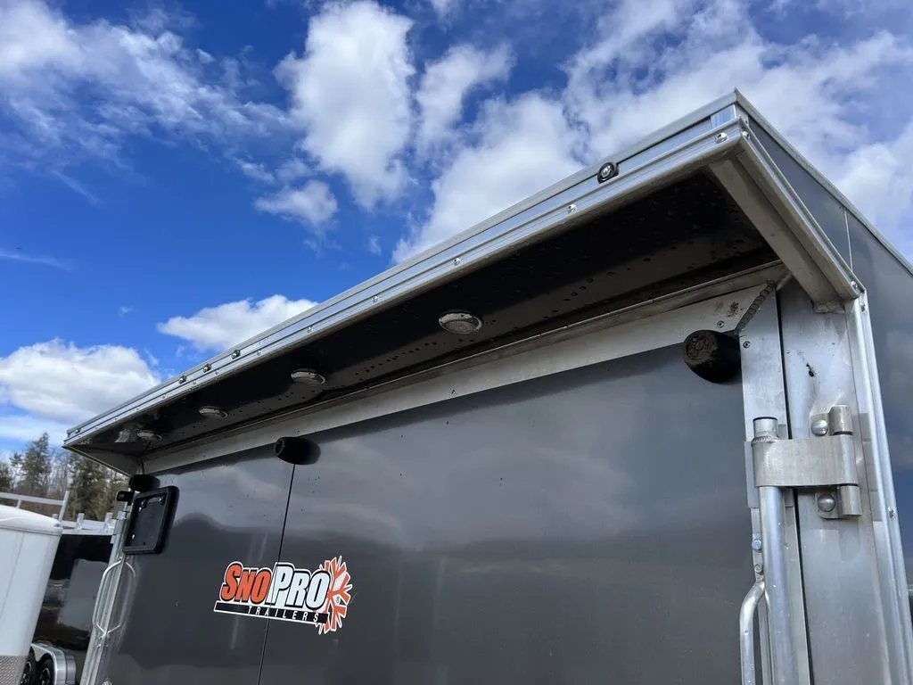 2023 Sno Pro 2-Place Snowmobile Trailer – Galvanized Package – Upper rear corner showing the roof overhang with integrated clearance and load lights
