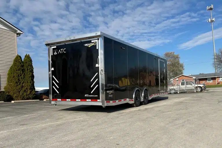 2026 ATC 28 ft Car Trailer – Premier Package – Rear three-quarter view of black enclosed trailer showing the ramp door