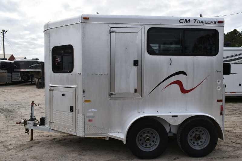 2001 CM Odyssey 2 Horse Trailer – Aluminum Floor – Side view of the silver trailer on a bright day