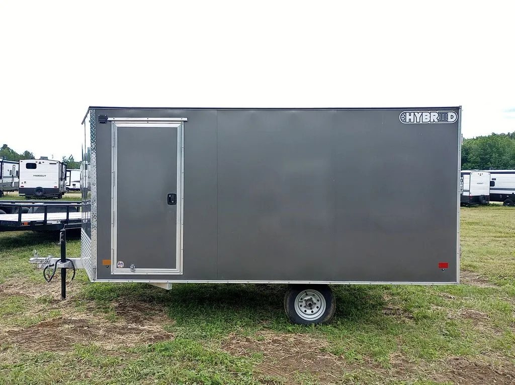 2022 Sno Pro Trailers Hybrid 2.0 – Charcoal Snowmobile Trailer – Side view showing the passenger side entry door and silver diamond plate