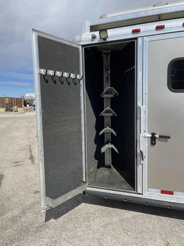2016 Hart Ultimate 4 Horse Trailer – Champagne, Hay Pod – Open rear tack compartment showing tiered saddle racks and bridle hooks