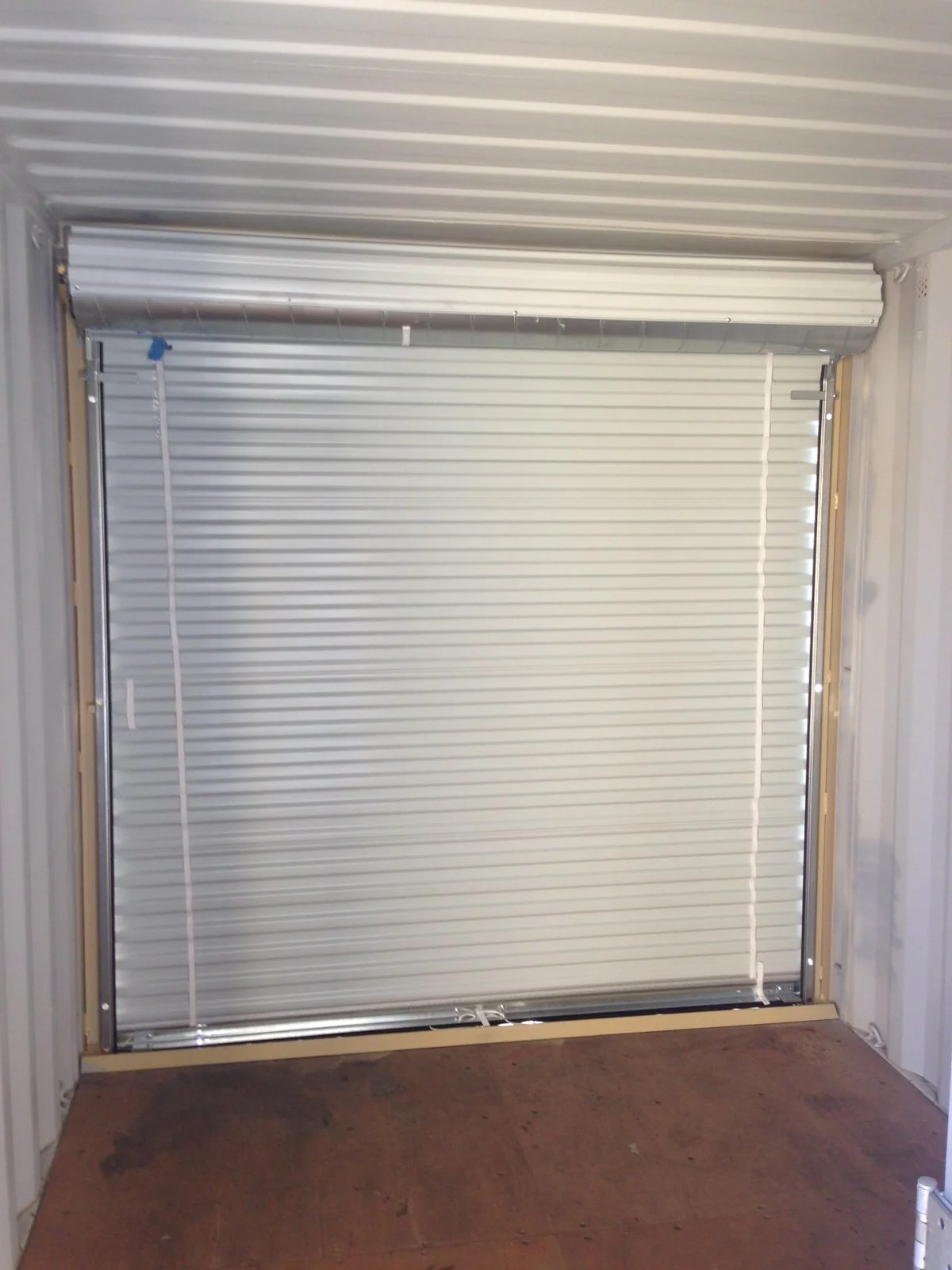 16ft Modified Storage Container – Front Roll-Up Door – closed roll-up door viewed from inside empty storage container