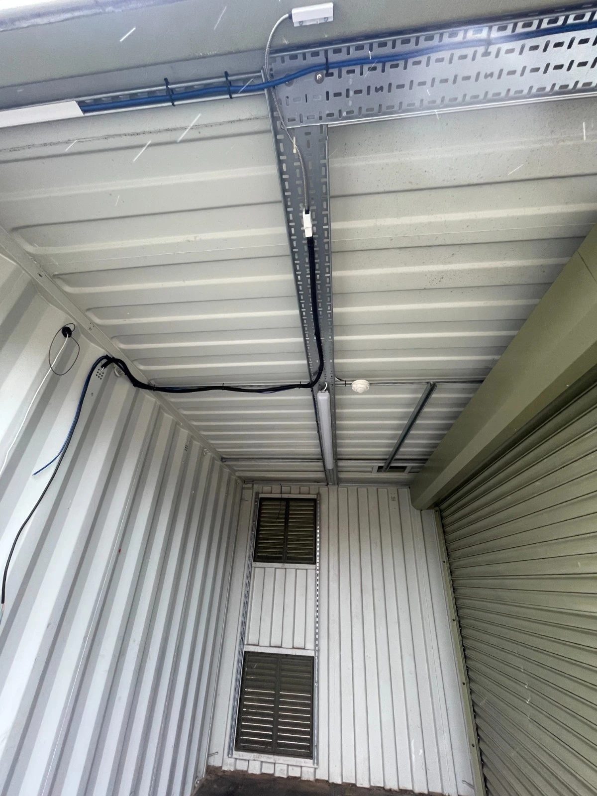 13ft Used Shipping Container – Lock Box Storage – empty container interior with ceiling wiring, vents and roller shutter