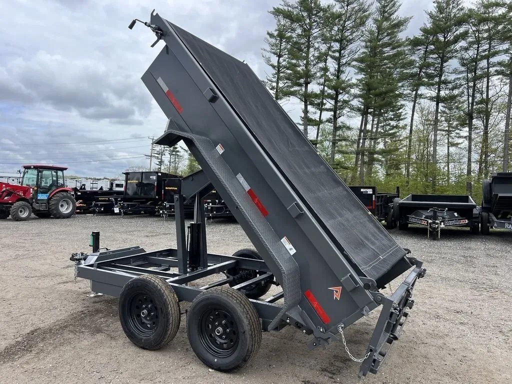 2024 RawMaxx 10 ft Dump Trailer – Shadow Grey – The dump trailer bed raised in the air showing the underside and lift mechanism