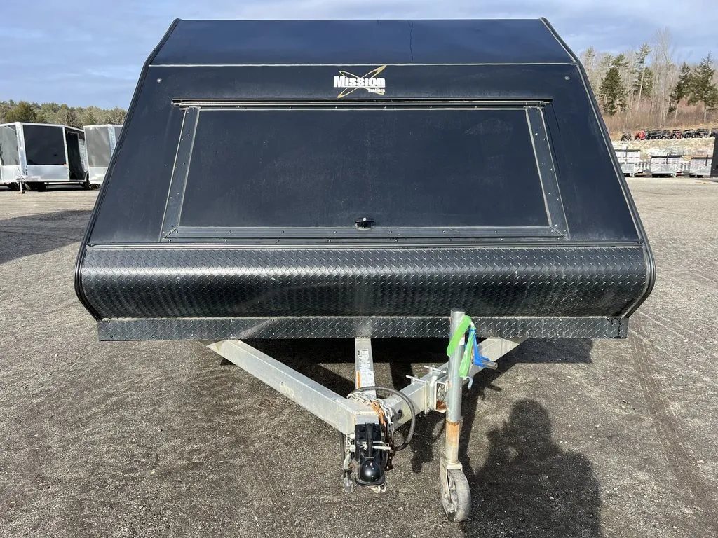 2021 Mission Trailers 2-Place Hybrid – Blackout Package – Straight-on front view of the black aerodynamic nose of the trailer