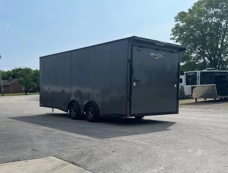 2025 Millennium 20 ft Car Hauler – Black-Out Package – Rear three-quarter view from the driver side showing the back of the enclosed trailer