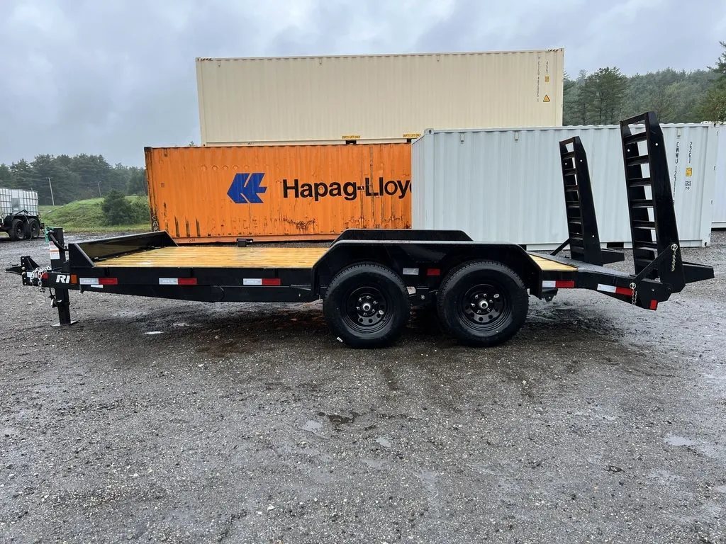 2024 Rice Trailers 16 ft Equipment Trailer – Toolbox – Full side profile view of the black equipment trailer against shipping containers