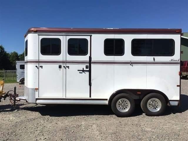 2007 Hawk 2 Horse Bumper Pull Trailer – Side Ramp – A direct side profile view of the white horse trailer with tandem axles