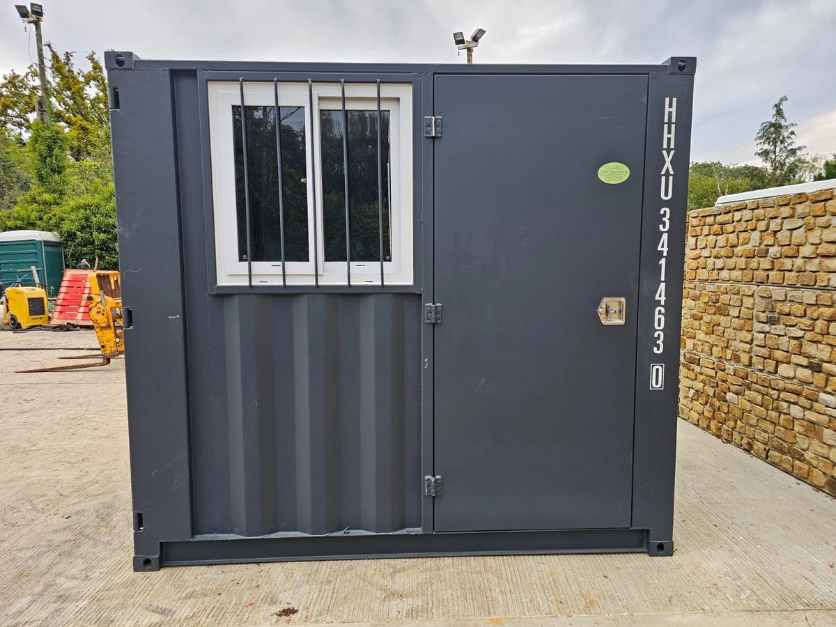 8ft New Shipping Container – Lockbox and Barred Windows – front of storage container with barred window and closed door