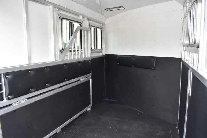 2019 Trailers USA 2 Horse Trailer – Aluminum, Dressing Room – Clean white interior of the horse trailer showing black padded kick mats