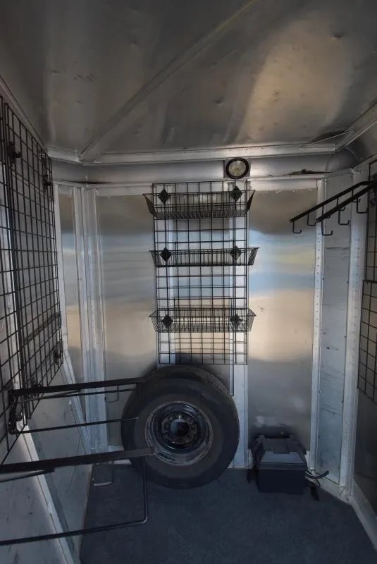 2008 C and C Trailers 4 Horse Bumper Pull – Hay Pod – Interior of the tack room showing a spare tire and wire storage racks