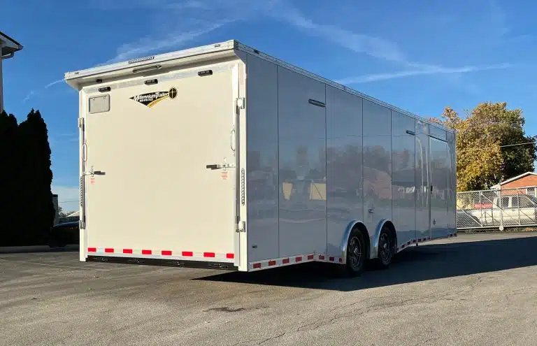 2026 Millennium 28 ft Car Hauler – White – Rear view showing the large ramp door and passenger side profile
