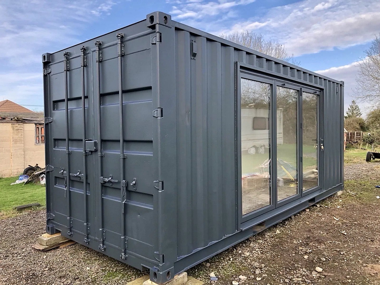 20ft Converted Container Office – Private Gym Configuration – Three-quarter exterior with closed cargo doors and glazed side entrance