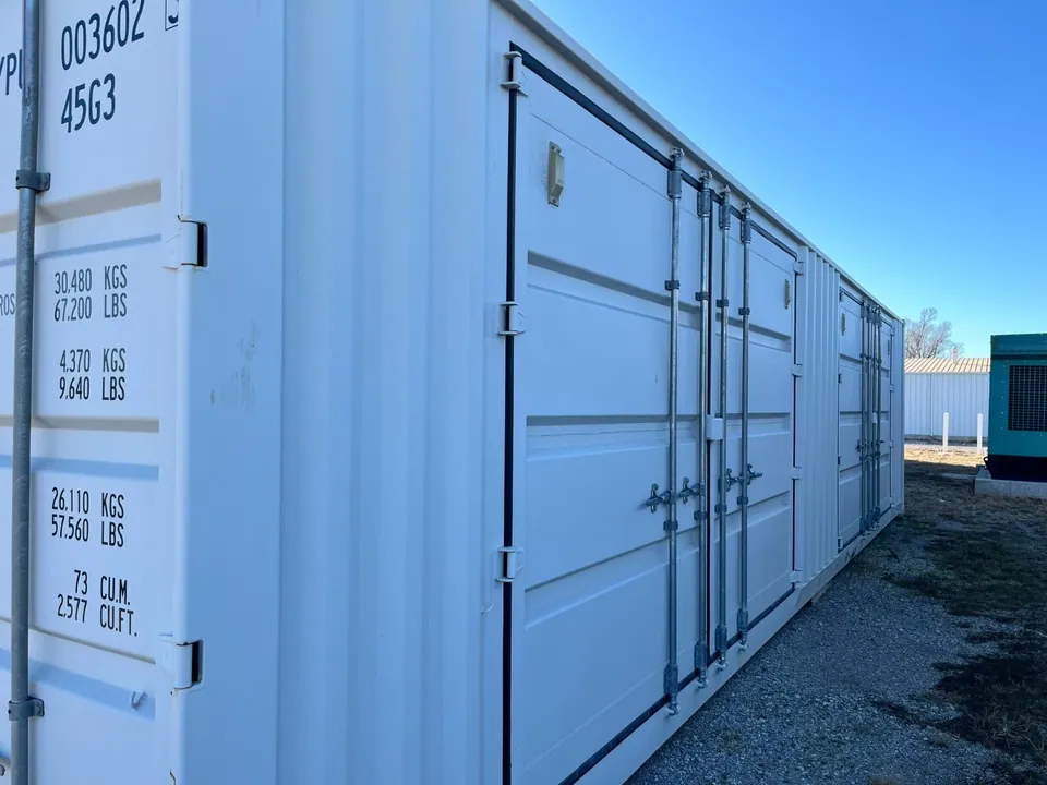 40ft High Cube Shipping Container – Side and End Doors – angled view of closed side doors and partial end door
