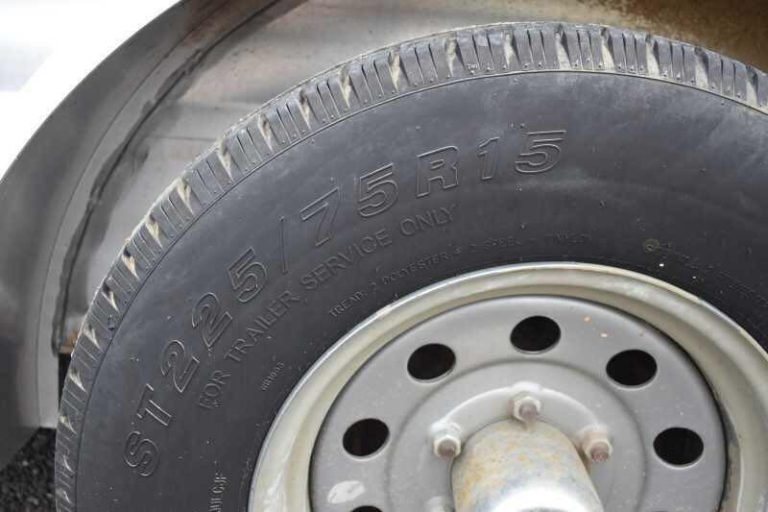 2012 CM 3 Horse Bumper Pull Trailer – Aluminum, Hayrack – Close-up view of a trailer tire showing the size markings and wheel