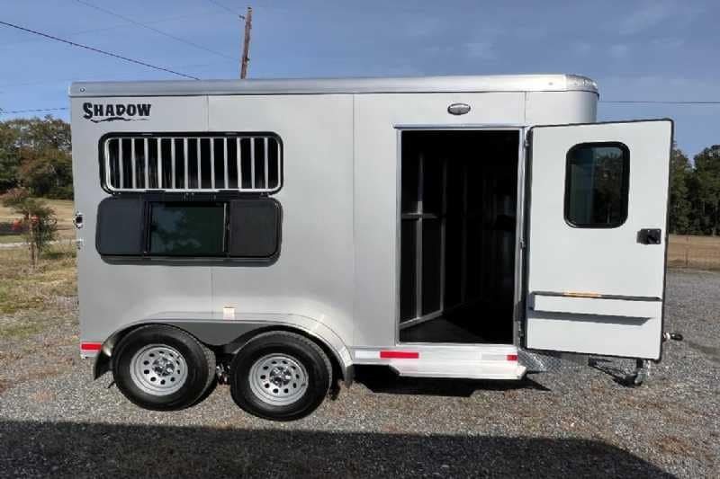 2024 Shadow 2 Horse Bumper Pull Trailer – Aluminum, Dressing Room – Exterior side view of the trailer with the dressing room door open