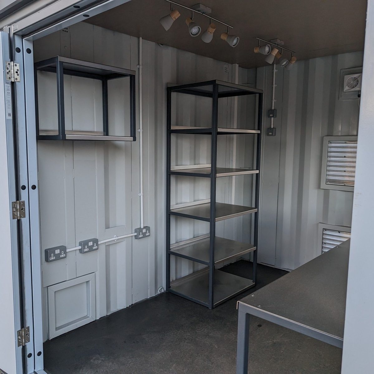 10ft Custom Pop-Up Bar Container – Full-Width Serving Hatch – container bar interior with metal shelving and work counter