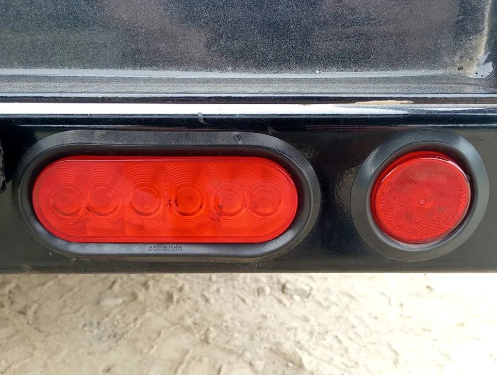 2024 PJ Trailers 14 ft Utility – Side Loading Ramps – Close up shot of the red LED tail lights on the trailer frame