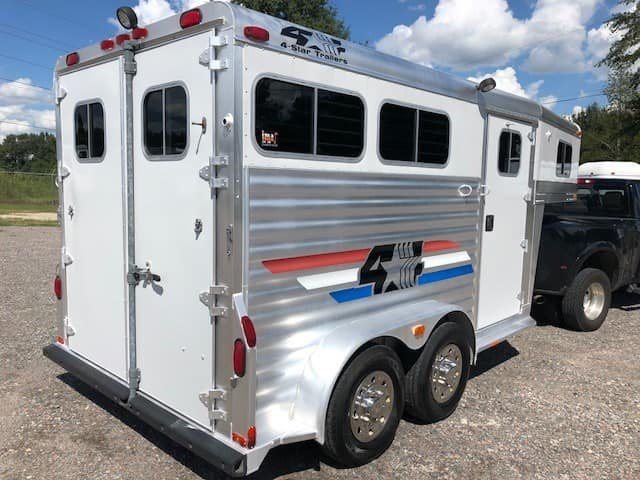 2004 4 Star 2 Horse Gooseneck Trailer – Slant Load, White – Rear three-quarter view from the driver side showing closed rear doors and side windows