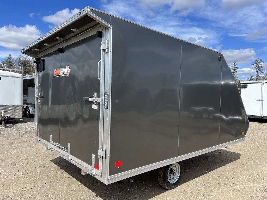 2023 Sno Pro 2-Place Snowmobile Trailer – Galvanized Package – Rear three-quarter view showing the closed ramp door and grey side panel
