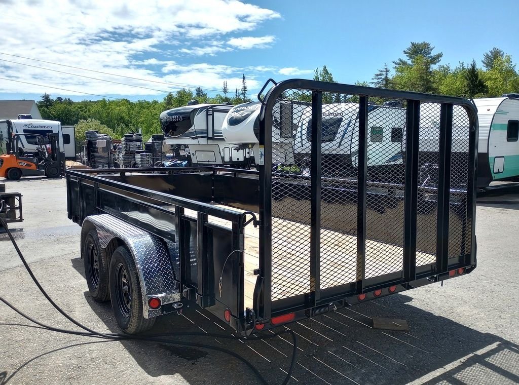 2024 PJ Trailers 14 ft Utility – Solid Metal Sides – Rear three-quarter view showing the mesh ramp gate and diamond plate fenders