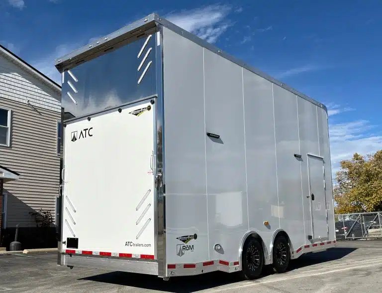 2026 ATC 22 ft Stacker – 14 ft Lift – Rear three-quarter view of a white stacker trailer with black wheels