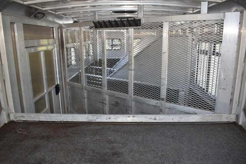 2006 Adam 7302 3 Horse Trailer – Aluminum, Dressing Room – Interior view of the tack room with carpeted floor and mesh partitions