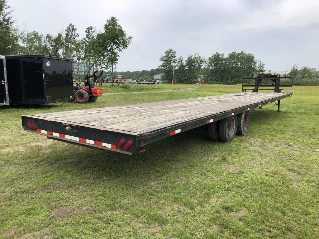 2002 Kaufman 40 ft Equipment Trailer – Toolbox – Elevated rear three-quarter view showing the long wooden deck of the trailer