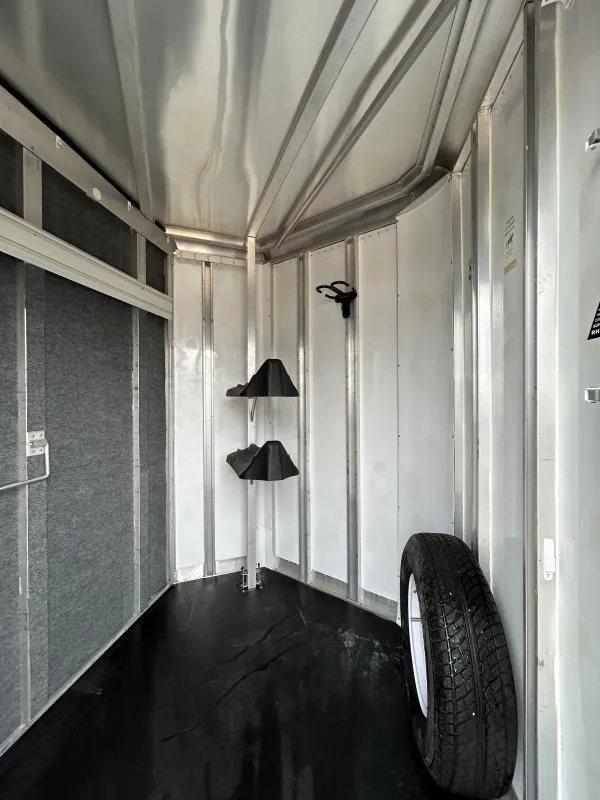 2007 Exiss SS-20 2 Horse Trailer – Collapsible Rear Tack – Interior tack room area showing a spare tire and bridle hooks