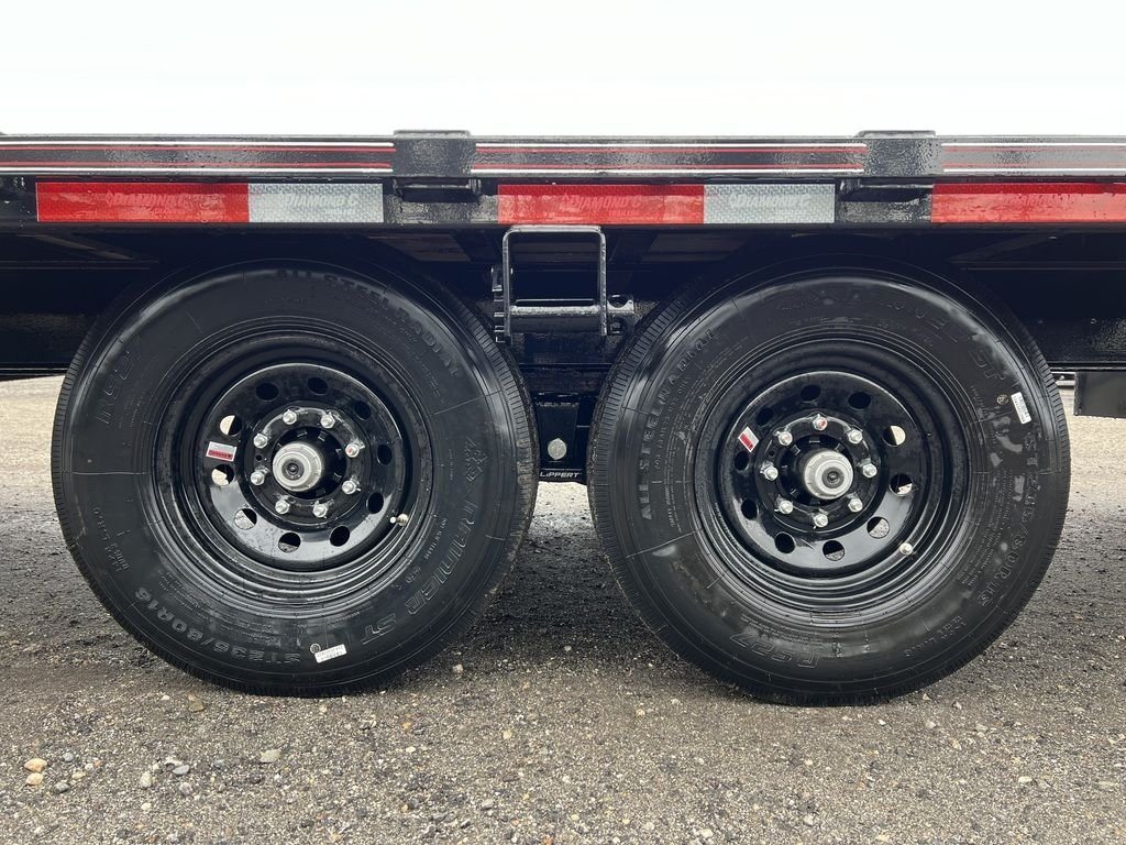 2024 Diamond C 24 ft Deckover – Blackwood Deck – Close up of the tandem axles and black wheels on the trailer