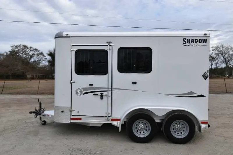 2016 Shadow 2HBP 2 Horse Bumper Pull Trailer – Aluminum – Full side profile of white horse trailer with closed door and windows