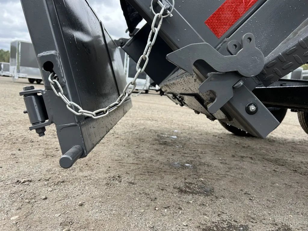 2024 RawMaxx 10 ft Dump Trailer – Shadow Grey – Detail of the rear door latching mechanism and safety chain on the dump bed