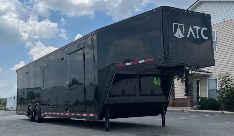 2026 ATC 40 ft Gooseneck – Black Trim – Front perspective showing the gooseneck hitch area and the long side panel