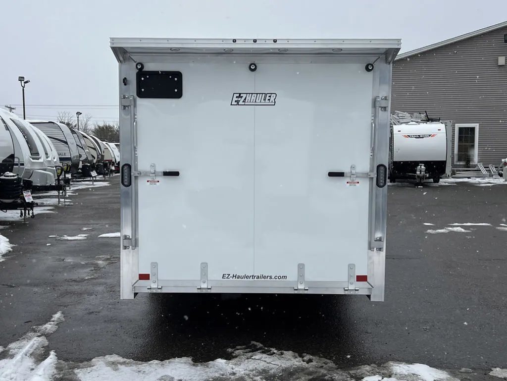 2024 E-Z Hauler 24 ft Trailer – Rear Canopy – Straight-on rear view of the white trailer with closed ramp and canopy