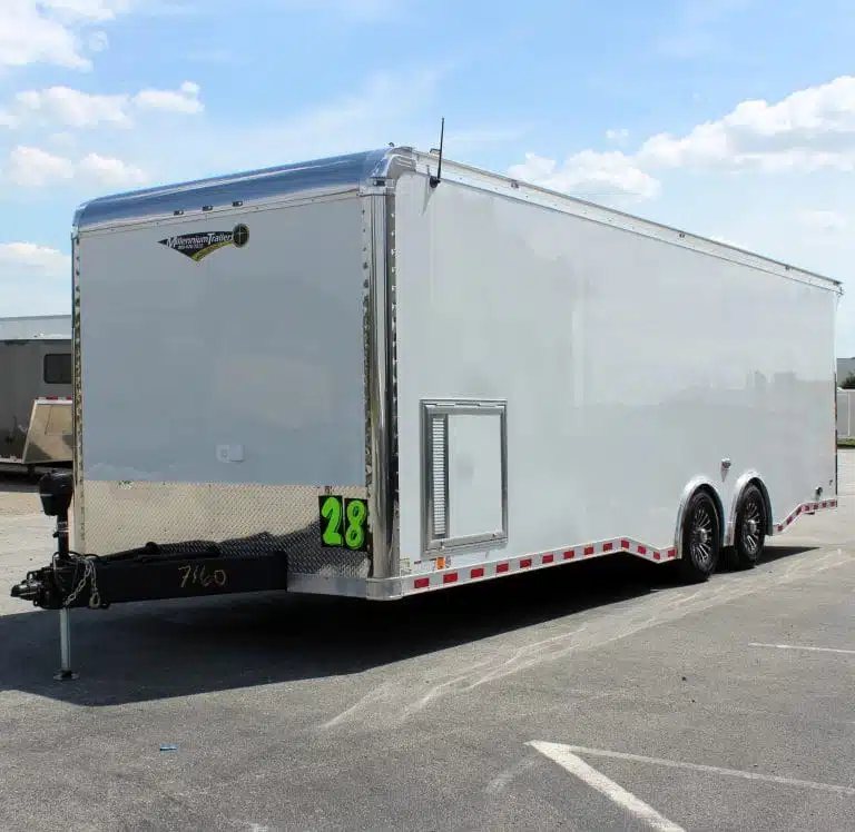 2025 Haulmark Edge 28 ft Enclosed Car Trailer – White – Front corner view of a white enclosed car trailer with hitch and wheels