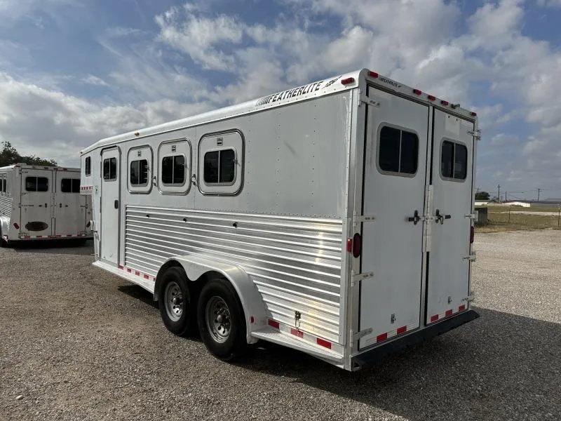 2000 Featherlite 3 Horse Gooseneck – Dressing Room – Rear three-quarter exterior view showing the windows, wheels, and rear doors