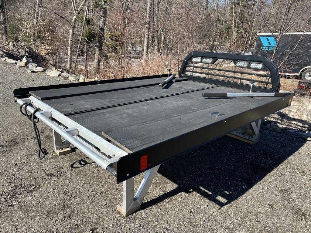 2023 Sno Pro 8 ft Sled Deck – Sliding Sides – Rear three-quarter view showing the deck surface and black side rails