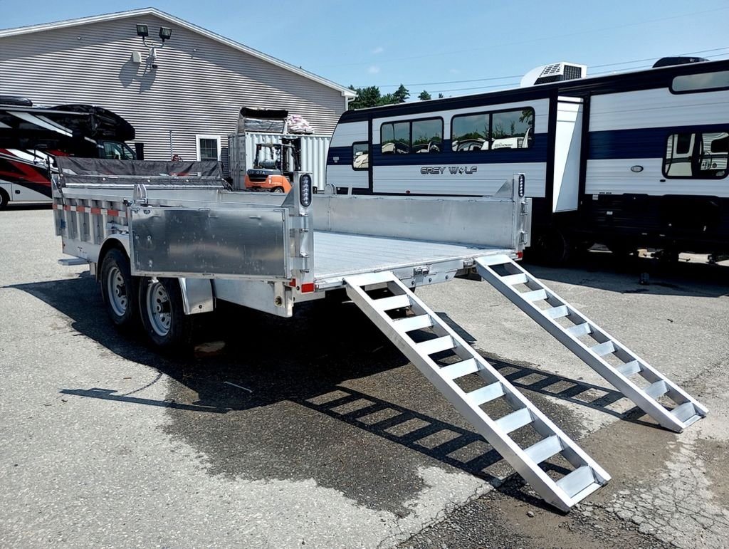 2025 Mission Trailers 16 ft Dump Trailer – Aluminum – Rear view of the trailer with the aluminum ramps extended for loading