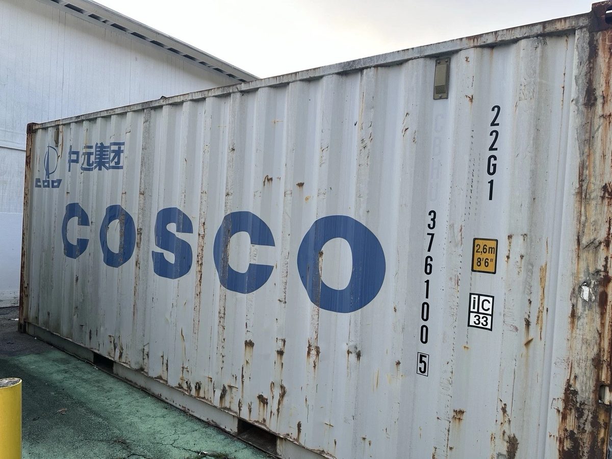 20ft Used Shipping Container – Lockable Storage – angled side view of weathered shipping container with rust