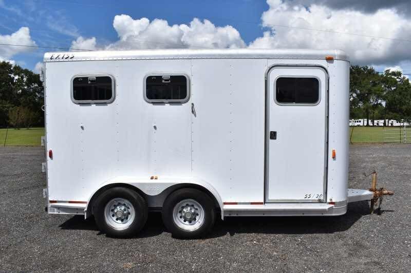 2002 Exiss SS20 2 Horse Trailer – Walk-Through Dressing Room – Direct side view of a white two horse trailer parked on gravel
