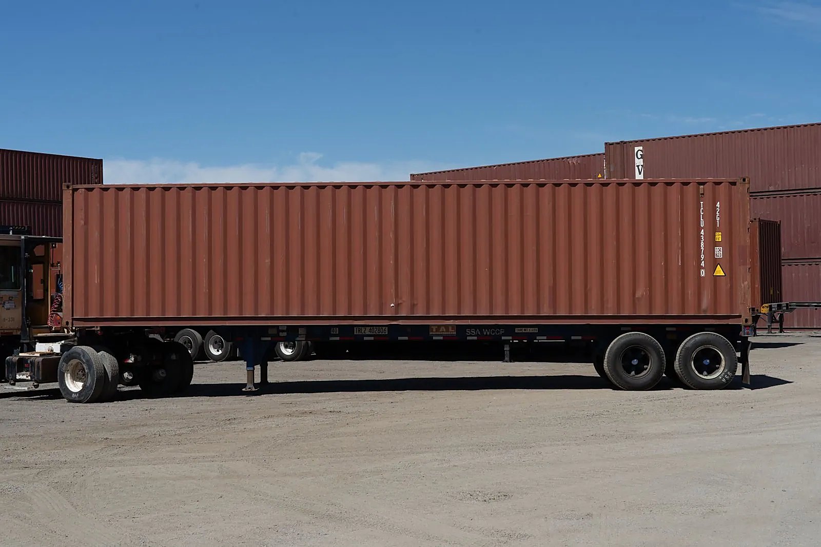40ft Used Cargo-Worthy Shipping Container – Standard Dry Storage – side view of brown shipping container on trailer