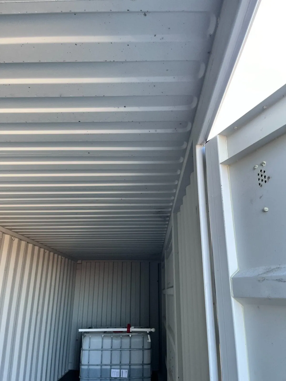 40ft High Cube Shipping Container – Side and End Doors – container interior with corrugated ceiling and liquid storage tank