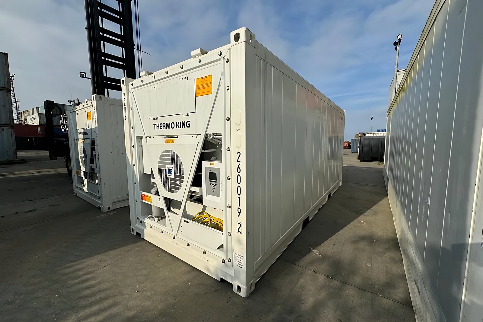 30ft Refrigerated Container – Stationary Cold Storage – White refrigerated container showing front cooling equipment and long side in a container yard