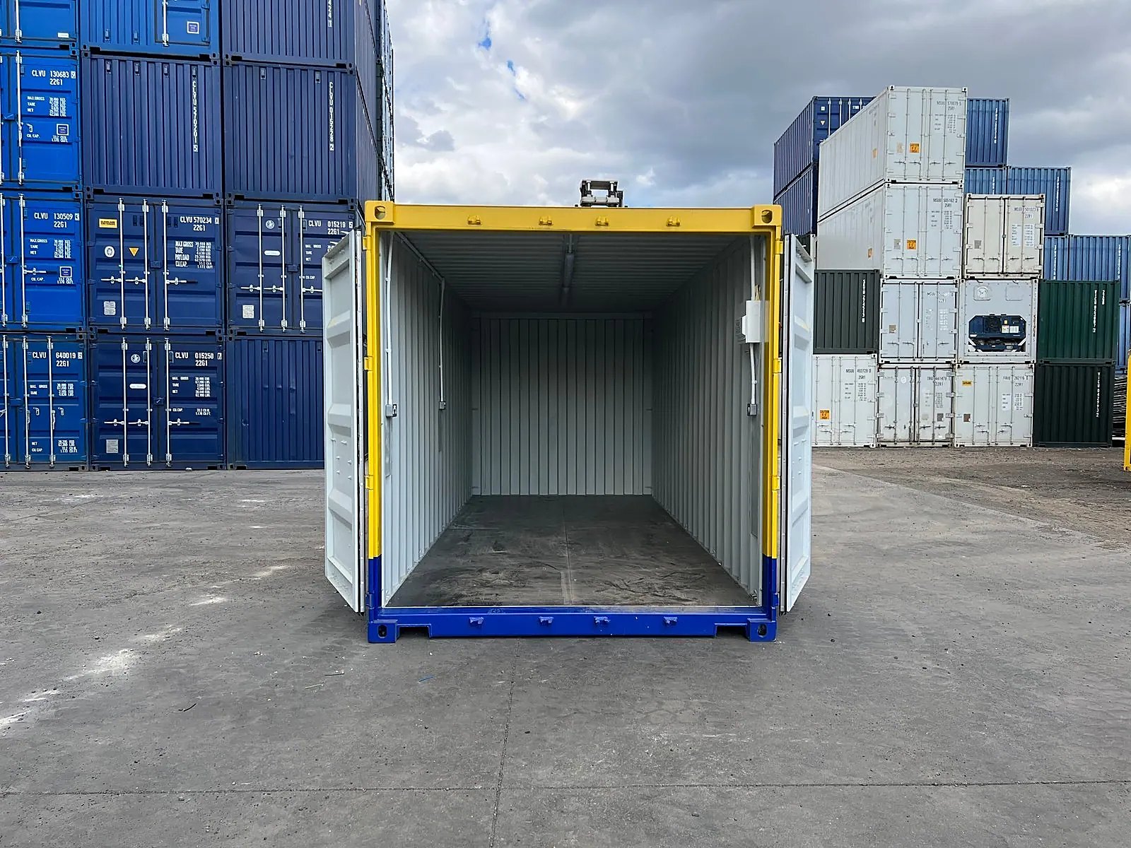 20ft One-Trip Modified Shipping Container – Electrical and LEDs – open cargo doors revealing empty container in storage yard