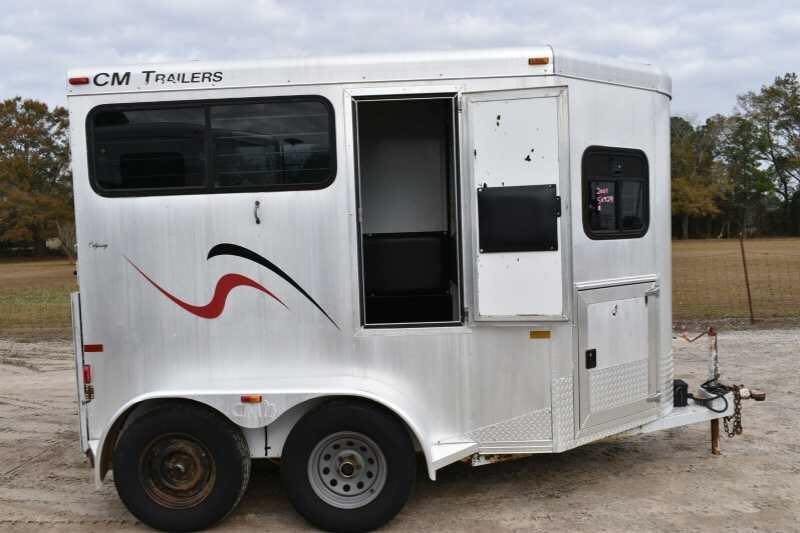 2001 CM Odyssey 2 Horse Trailer – Aluminum Floor – Side view of the silver trailer with the side entry door held open