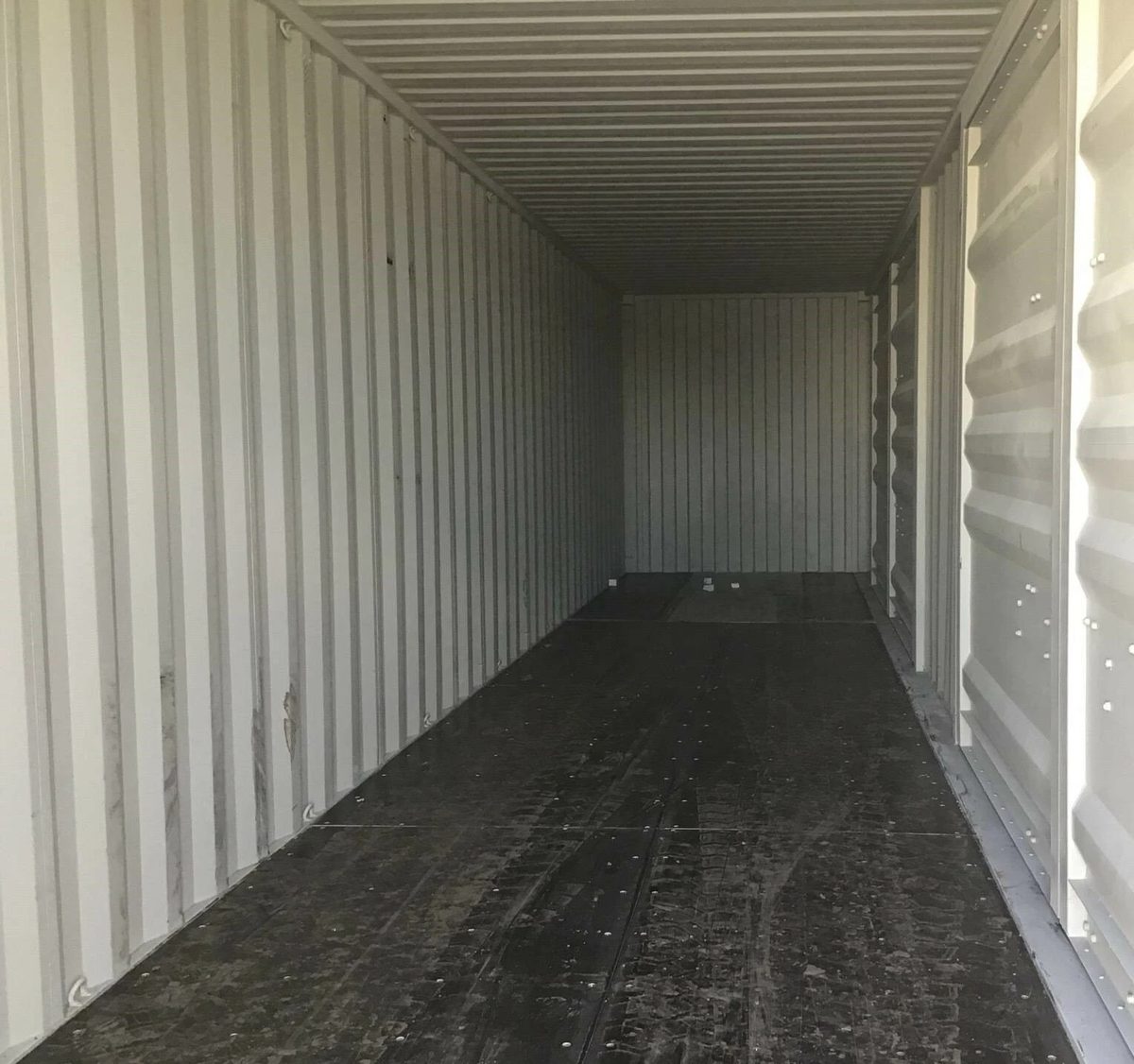 40ft High Cube Shipping Container – One-Trip, Two Side Doors – empty container interior with corrugated walls and dark plywood floor
