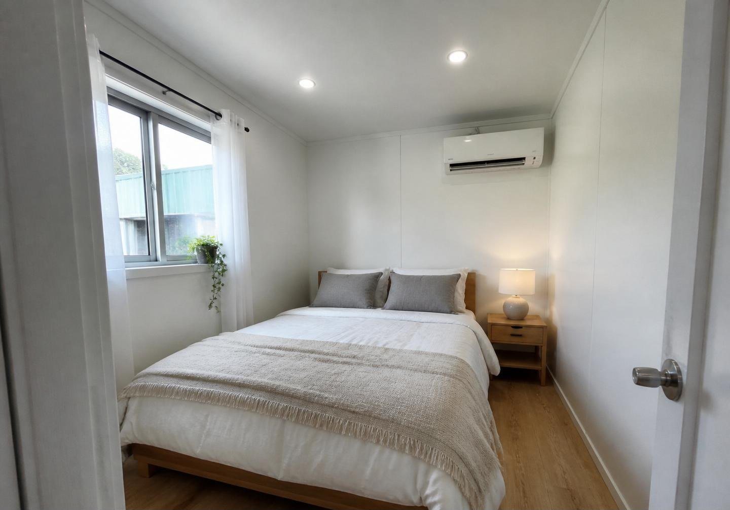 40ft Prefab Container Home – Loft & Covered Deck – Bedroom with nightstand and lamp — furniture and appliances shown for illustration only; not included
