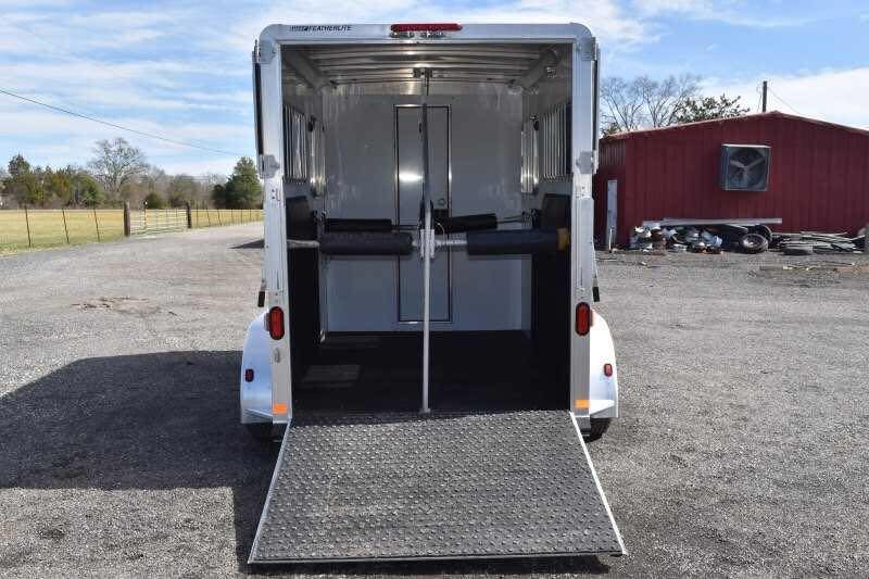 2005 Featherlite 2HST Horse Trailer – Walk-Through Dressing Room – Open rear ramp showing the interior horse stalls and divider